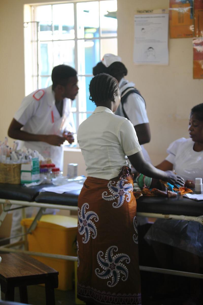 Health workers attend to a baby in Malawi