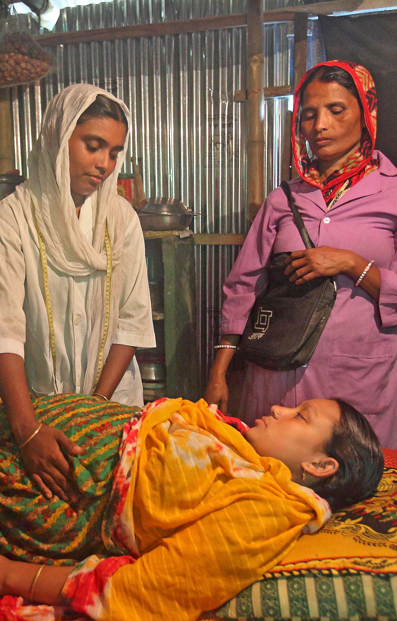 The patient, pictured here with a birth attendant and a community health worker, is an active participant in her own well-being. Photo courtesy: BRAC