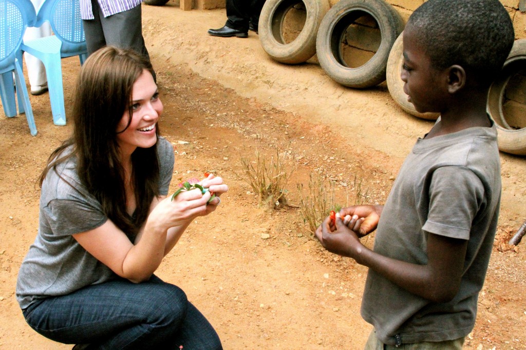 PSI Ambassador Mandy Moore visits with the patient of a community health worker in a small village in Cameroon. Courtesy PSI. 