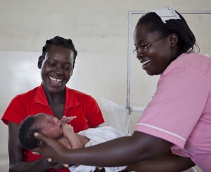 Esther Madudu delivering a baby, Uganda.  Courtesy Amref Health Africa.